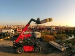 New Telehandler working under the setting sun